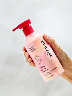 Hand holding Eva NYC Lift Off Volume Shampoo
